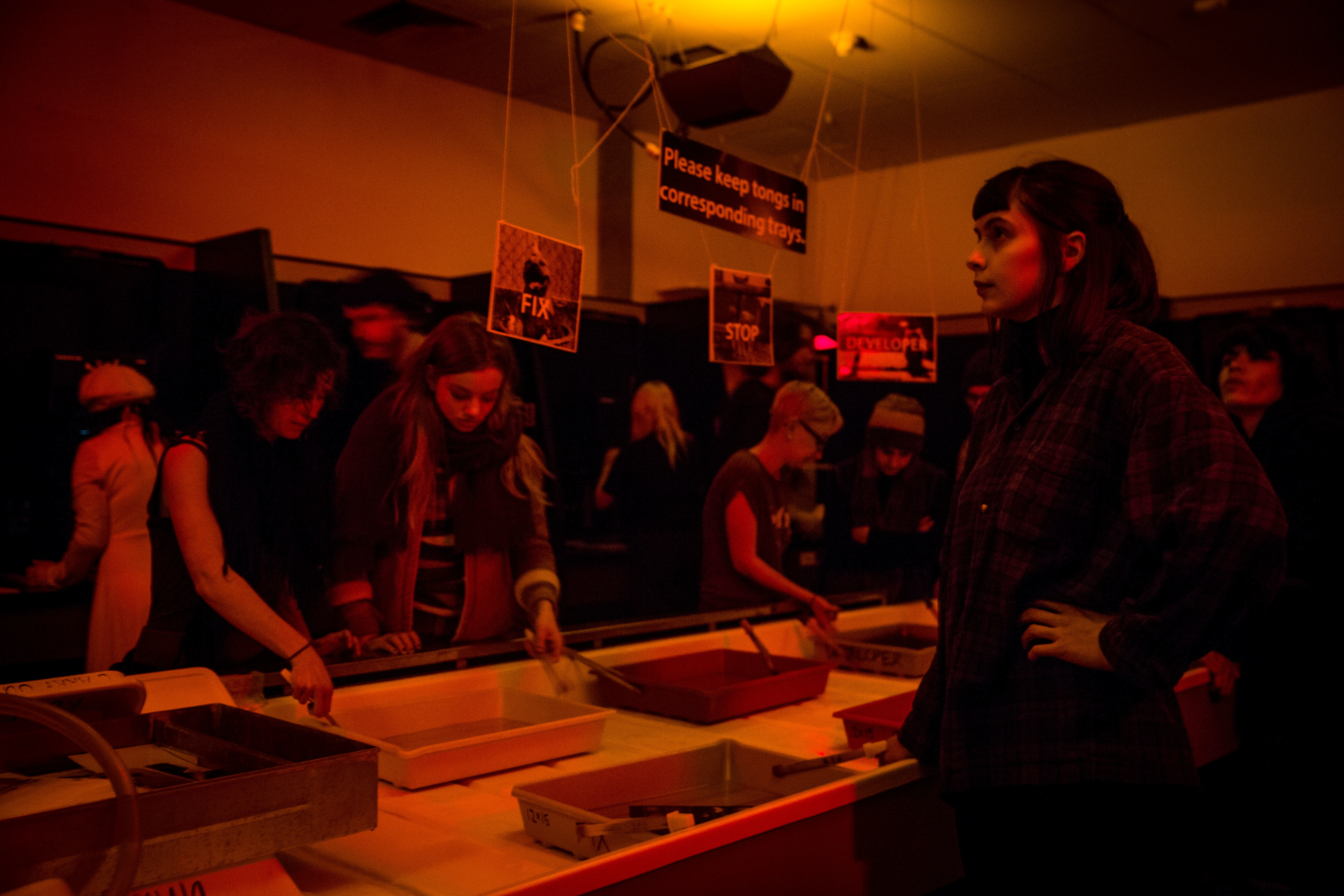 Students in dark room, developing photos