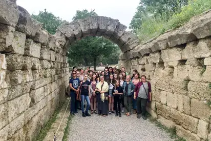 a group of students standing under an archway