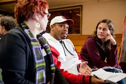 three people sitting together having a discussion