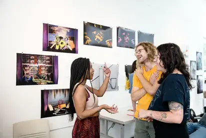 three students talking in an art gallery