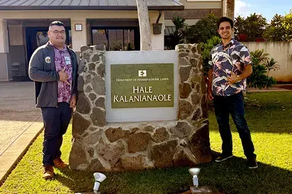 Jaren Tengan (L) with Keith Adams (R) standing outside their workplace, Department of Hawaiian Homelands, in Hawaii.