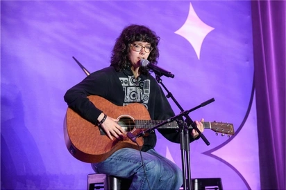 Ella Colwell playing guitar