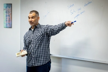 tyrus smith teaching in front of a whiteboard