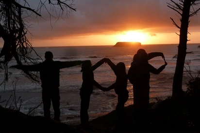 Students on the beach using their bodies to spell TOP