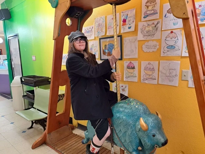 Justine Cabell riding a small blue buffalo
