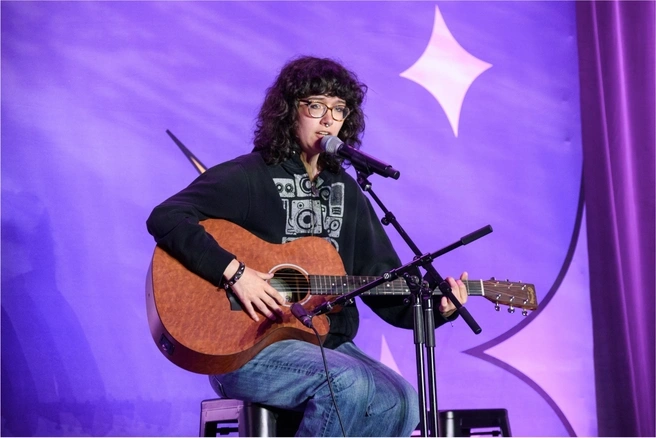 Ella Colwell playing guitar