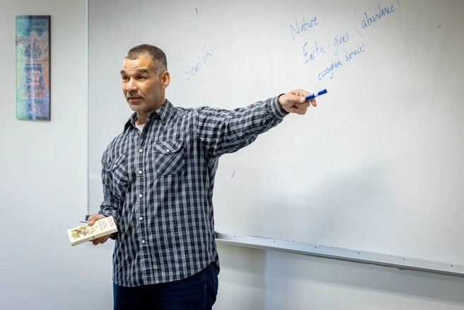 tyrus smith teaching in front of a whiteboard