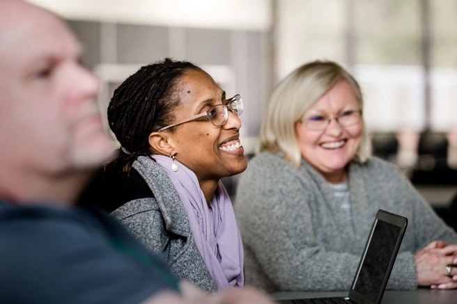 Students smiling and participating in class