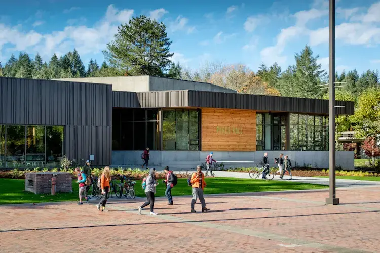 Purce Hall with students walking across the front courtyard and lawn.