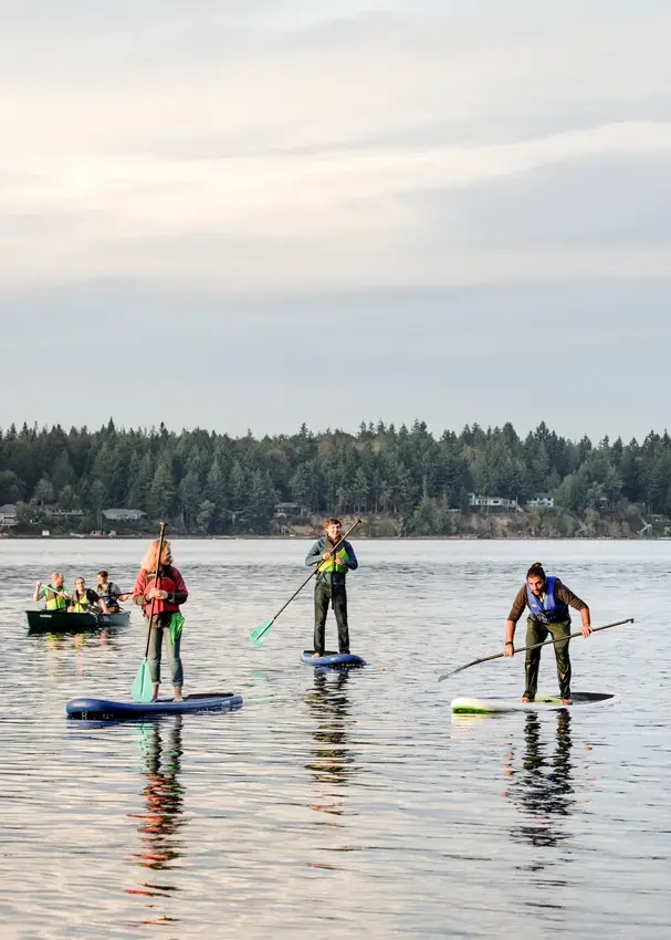 Students on kayaks and paddleboards