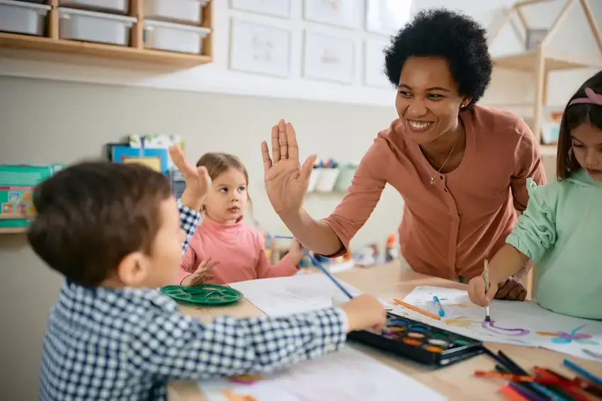 a teacher giving high fives to their students