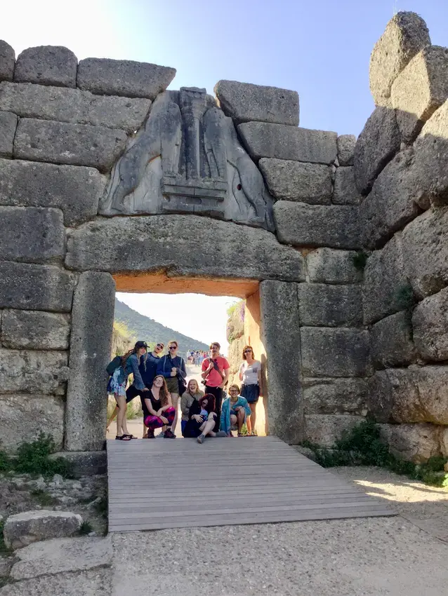 a group of students under an archway