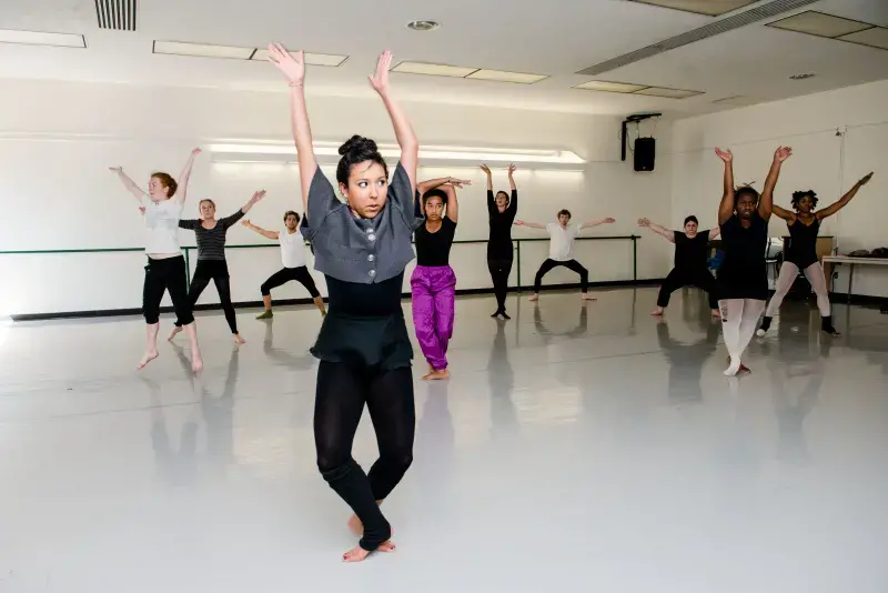 A group of dancers practice ballet moves in a CRC dance studio