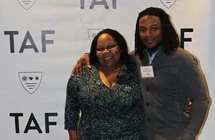 Marcenia Milligan and Talib Williams standing side by side in front of TAF backdrop