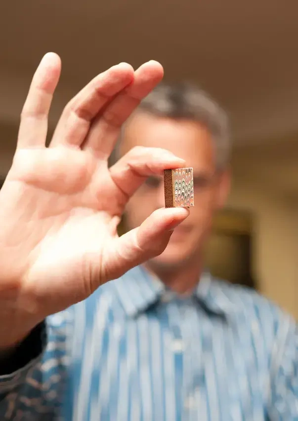 a close of a hand with a very tiny book, about the size of a thumbnail