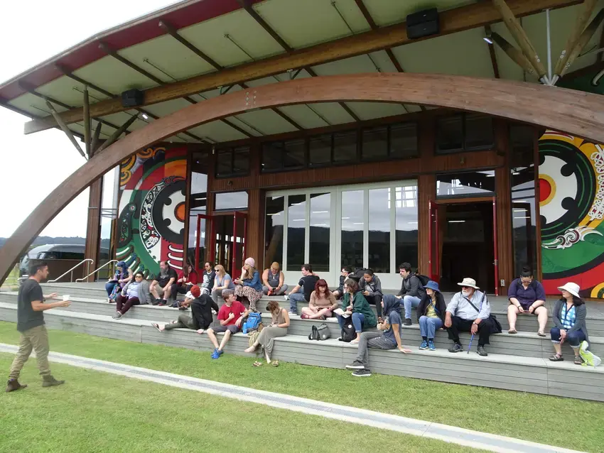 a class sitting on the steps on the native decolonization course abroad