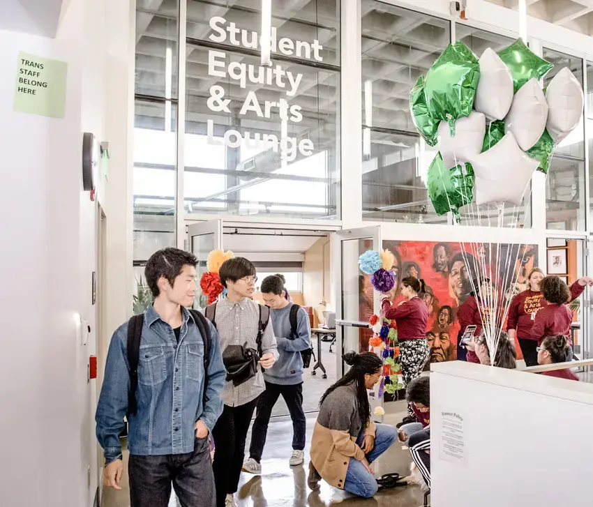 A group of people enter the Student Equity and Arts Lounge on the Olympia campus
