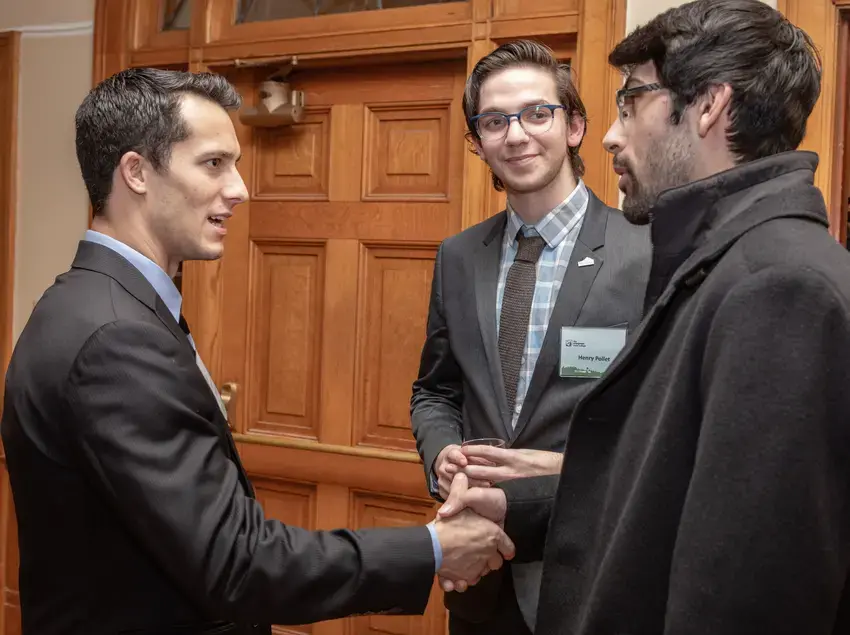 Student shaking hands with a state legislator