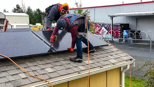 Solar panel technicians working at Quixote Village